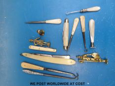 A quantity of button hooks, folding knives, pipe tampers etc,