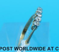 An 18ct gold ring set with five old cut diamonds (size O)