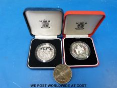 A Queen Mother cased 90th Birthday crown, a Solomon Islands silver 10 dollars,