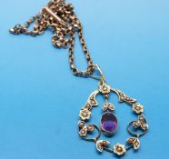 An Edwardian 15ct gold pendant set with amethyst and pearls on a gold chain