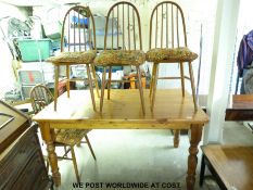 A pine kitchen table and four probably Ercol chairs (H78 x W152 x D91cm)