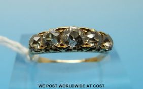 An 18ct gold ring set with five old cut diamonds, the centre stone approximately 0.
