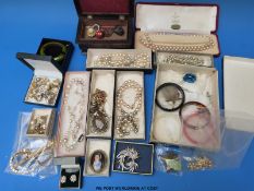 A large collection of costume jewellery to include faux pearls, a transfer printed brooch,