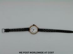 A 9ct gold cased ladies wristwatch with enamel face and Arabic numerals and a silver fob watch with
