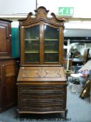 A 19thC style bureau bookcase with scrolling pediment, twin doors to top section,
