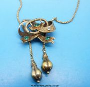 A yellow metal necklace in the form of a stylised bow and buckle with chased decoration and set