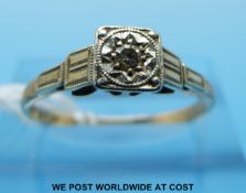 An Art Deco yellow metal ring marked 9ct gold set with a diamond in a stepped platinum setting,