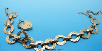 A 15ct gold bracelet of circular links with padlock clasp (23.