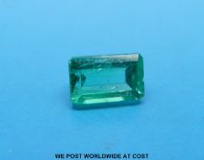 A loose emerald cut emerald measuring approximately 3.