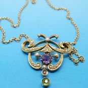 An Edwardian pendant necklace set with amethysts, peridot and seed pearls 4x3.5cm.