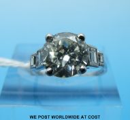 A white metal ring set with a round brilliant cut diamond measuring approximately 2.