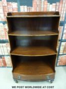 An inlaid and crossbanded waterfall bookcase with single bow fronted drawer to base,