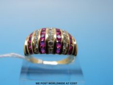 An 18ct gold ring set with rows of diamonds and rubies (size R)