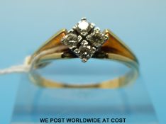An 18ct gold ring set with four diamonds in a diamond shaped setting (size Q)