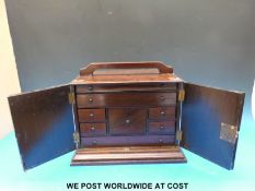 A rosewood or similar collector's cabinet,