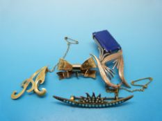 A 9ct gold brooch in the form of a bow, an 18ct gold brooch in the form of a letter 