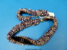 A matching necklace and bracelet set with amethyst and onyx beads