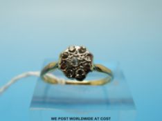 An 18ct gold ring set with nine diamonds in platinum floral setting (size N)
