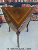 A late 19thc occasional table with curved drop leaves, raised on carved legs united by a shelf (H71,