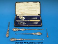 Four various hallmarked silver button hooks,