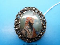A white metal brooch set with a miniature on ivory of an Indian man