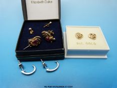 A pair of 9ct gold earrings each set with a ruby and a diamond,