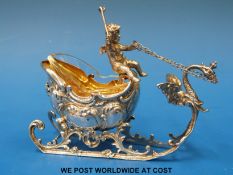 A continental white metal troika salt with gilt wash interior and glass liner (length 10cm)