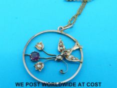 An Edwardian 9ct gold pendant in the form of a swallow with flowers,