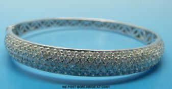 An 18ct white gold bangle,