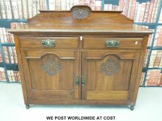 A carved walnut Art Nouveau sideboard (height 110cm width 138cm depth 50cm)