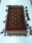 An Afghan rug with geometric design,