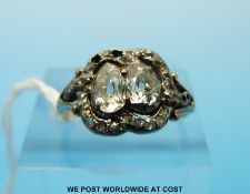 A gold ring set with two pear cut diamonds of approximately 038 and 0.