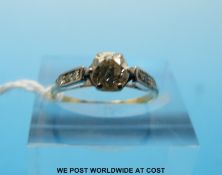 An 18ct gold ring set with a round cut diamond of approximately 0.
