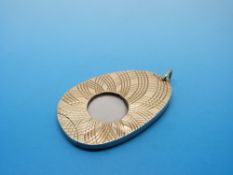 A cigar cutter mounted between two 9ct gold floral plates