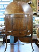 A Georgian mahogany bow-fronted corner washstand with single cupboard and drawer (H122, W63,
