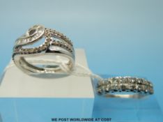 A white metal ring set with two rows of diamonds and a 9ct white gold ring set with diamonds in a