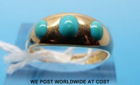 An 18ct gold ring set with three oval turquoise cabochons (size N)