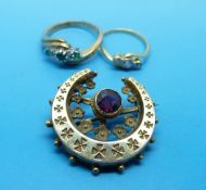 A 9ct gold ring set with a diamond and emeralds,