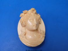 An ivory brooch carved in the form of a lady