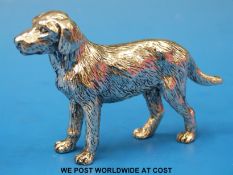 A white metal model of a dog (length 9cm,