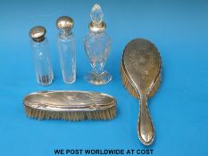Three hallmarked silver and white metal-mounted dressing table bottles,