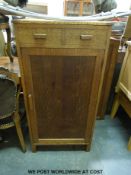 An oak cupboard with lift up vanity unit to top (height 125cm width 62cm depth 47cm)