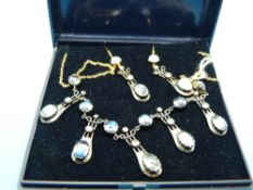 A yellow metal necklace set with diamonds and moonstones with matching earrings