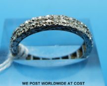 A white metal ring (believed to be white gold) set with diamonds (size N)