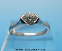 A platinum ring set with a round brilliant cut solitaire diamond of approximately 0.