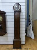 An oak granddaughter clock with carved decoration to the case and two train movement,