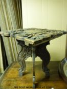 A mahogany framed mirror and a carved folding table.