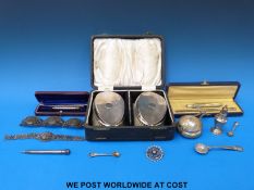 A quantity of hallmarked silver items including a cased gents brush and comb set, a tea strainer,