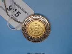 A yellow metal brooch set with a gold one Pahlavi coin (15.