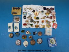 A collection of novelty enamel badges including brewery related,